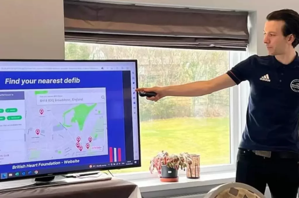 First aid training demonstrating how to locate the nearest defibrillator on a map at Movement Therapy Dorset