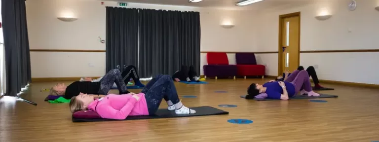 Pilates instructor guiding a client through tailored exercises to improve back pain and sports performance in Broadstone.