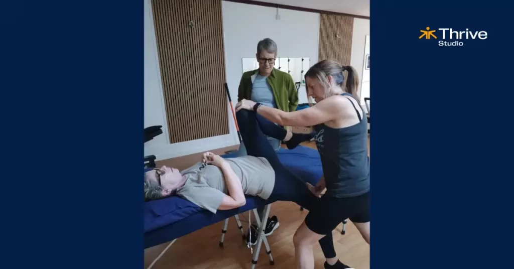 Students practicing sports massage techniques on each other during hands-on Bournemouth course